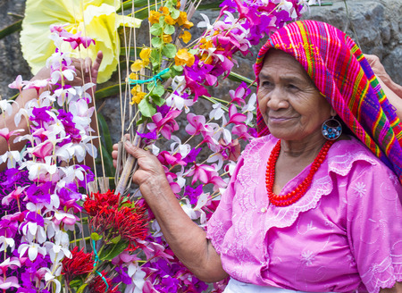 PANCHIMALCO , EL SALVADOR - MAY 08 : A Salvadoran woman decorates palm fronds with flowers during the Flower & Palm Festival in Panchimalco, El Salvador on May 08 2016のeditorial素材