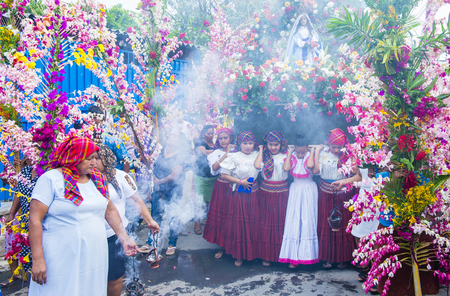 PANCHIMALCO , EL SALVADOR - MAY 08 : Salvadoran girls carry an altar with a statue of Virgin Mary during the procession of the Flower & Palm Festival in Panchimalco, El Salvador on May 08 2016のeditorial素材