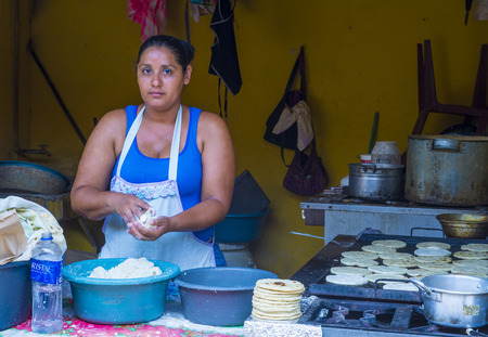 SUCHITOTO , EL SALVADOR  - MAY 07 : Salvadoran woman prepares Popusas in Suchitoto El Salvador on May 07 2016. Popusa is a traditional Salvadoran dish made of corn tortillaのeditorial素材