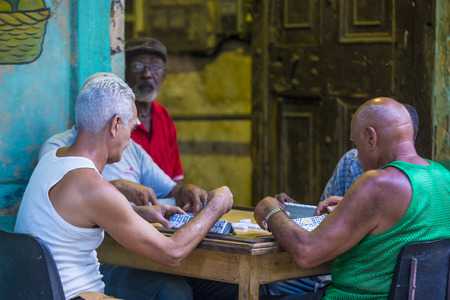 HAVANA, CUBA - JULY 18 : Unidentified men play dominos on the street on July 18 2016 in Havana , Cuba. Domino is one of the most popular games in Cubaのeditorial素材