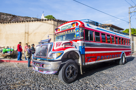 ANTIGUA, GUATEMALA - JULY 31: A typical Guatemalan Chicken Bus in Antigua, Guatemala on July 31, 2015. Chicken Bus It's a name for colorful, modified and decorated bus in various Latin American countriesのeditorial素材