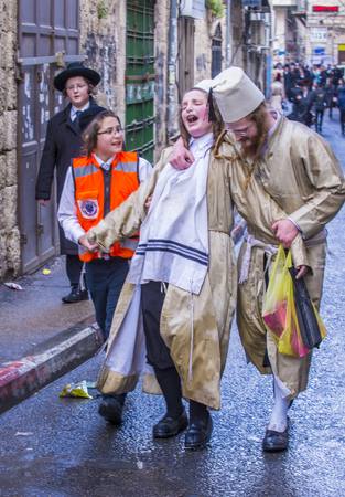 JERUSALEM - MARCH 13 : Ultra Orthodox drunk boys during Purim in Mea Shearim Jerusalem on March 13 2017 , Purim is a Jewish holiday celebrates the salvation of the jews from genocide in ancient Persiaのeditorial素材