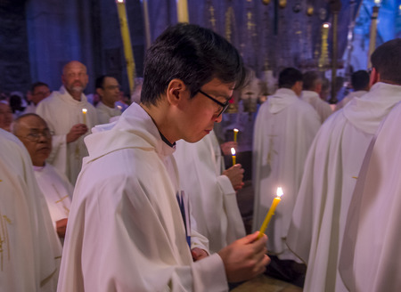JERUSALEM - APRIL 13 : A procession of monks holding candels during Easter in the church of the holy sepulcher in Jerusalem Israel on April 13 2017のeditorial素材