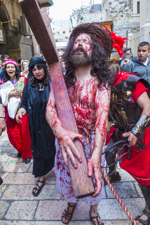 JERUSALEM - APRIL 14 : Christian pilgrims re-enact the crucifixtion of Jesus along the Via Dolorosa in Jerusalem during Good friday on April 14 2017のeditorial素材