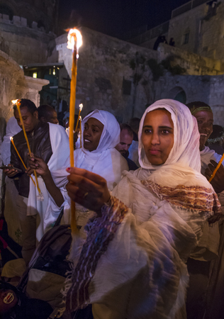 JERUSALEM - APRIL 15 : Ethiopian Orthodox pilgrims participates in the Holy fire ceremony at the Ethiopian section of the Holy Sepulcher in Jerusalm Israel on April 15 2017のeditorial素材