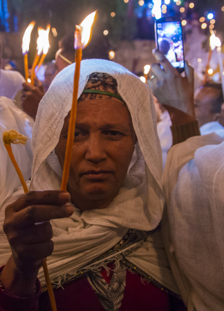 JERUSALEM - APRIL 15 : Ethiopian Orthodox pilgrim participates in the Holy fire ceremony at the Ethiopian section of the Holy Sepulcher in Jerusalm Israel on April 15 2017のeditorial素材