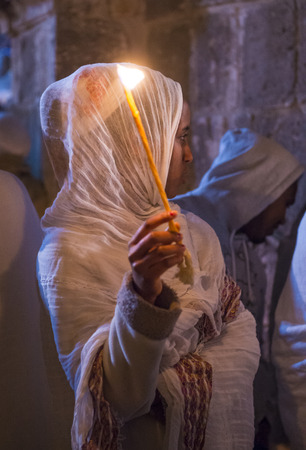 JERUSALEM - APRIL 15 : Ethiopian Orthodox pilgrim participates in the Holy fire ceremony at the Ethiopian section of the Holy Sepulcher in Jerusalm Israel on April 15 2017のeditorial素材