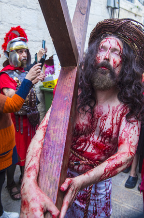 JERUSALEM - APRIL 14 : Christian pilgrim re-enact the crucifixtion of Jesus along the Via Dolorosa in Jerusalem during Good friday on April 14 2017のeditorial素材