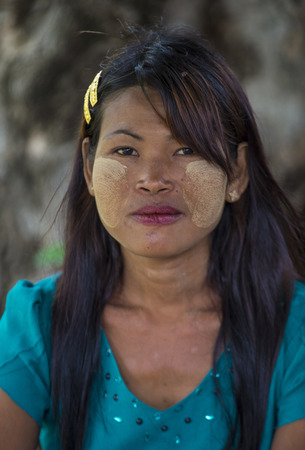MANDALAY , MYANMAR - SEP 03 : Portrait of Burmese girl with thanaka on face on Mandalay Myanmar on September 03 2017. Thanaka is paste made from ground barkのeditorial素材