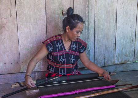 QUANG NAM , VIETNAM - OCT 07 : Woman from the Cotu Minority weaves with a strap loom in Quang Nam Vietnam on October 07 2017. The Cotu minority mostly live in central Vietnamのeditorial素材