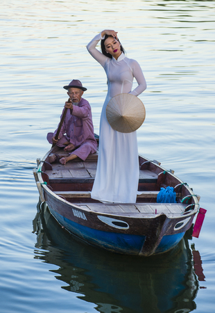 HOI AN , VIETNAM - OCT 04 : Vietnamese woman wearing Ao Dai dress during the Mid autumn festiaval in Hoi An ,Vietnam on October 04 2017 Ao Dai is a Vietnamese traditional clothingのeditorial素材