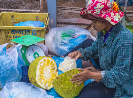 SIEM REAP , CAMBODIA - OCT 18 : Cambodian woman selling Jackfruit in a market in Siem Reap Cambodia on October 18 2017. Agriculture is the main industry in Cambodiaのeditorial素材