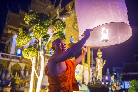 CHIANG MAI , THAILAND - NOV 03 : Buddhist monk launch sky lantern during Yee Peng festival in Chiang Mai , Thailand on November 03 2017のeditorial素材