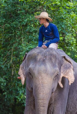 SIEM REAP , CAMBODIA - OCT 15 : Cambodian man riding an Elephant at the Angkor Thom in Siem Reap Cambodia on October 15 2017 , Angkor Thom was the last and capital city of the Khmer empire.のeditorial素材