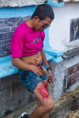 GASAN , PHILIPPINES - MARCH 30 : Filippino man hit himselve on Good Friday at the cemetary in Gasan, Marinduque Island, The Philippines on March 30 2018のeditorial素材