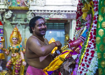 SINGAPORE - FEB 24 : Indian man decorating idol in Sri Veeramakaliamman temple in Little India, Singapore on February 24 2018 It is one of the oldest temples in Singapore.のeditorial素材