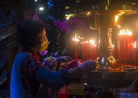 TAIPEI - FEB 18 : Taiwanese woman lights a candle during Chinese new year in Longshan temple in Taipei Taiwan on February 18 2018. The temple was built in 1738のeditorial素材
