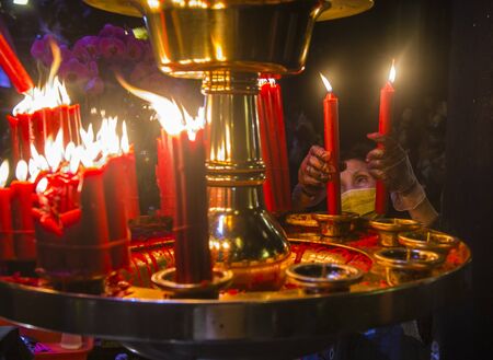 TAIPEI - FEB 18 : Taiwanese woman lights a candle during Chinese new year in Longshan temple in Taipei Taiwan on February 18 2018. The temple was built in 1738のeditorial素材