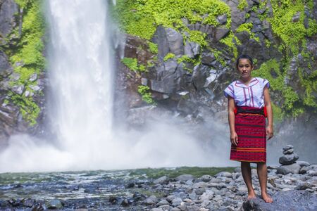 BATAD, PHILIPPINES - MAY 02 : Girl from Ifugao Minority near a waterfall in Batad the Philippines on May 02 2018. The Ifugao minority mostly live in the mountains of north Philippinesのeditorial素材