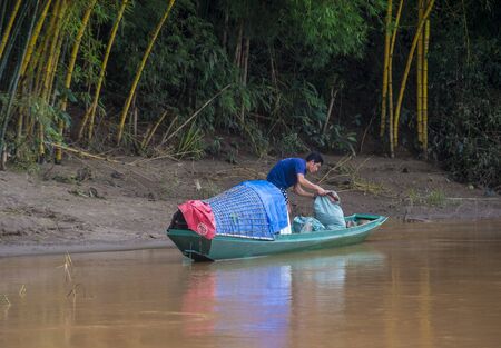 LUANG PRABANG , LAOS - AUG 12 : Laotian fisherman at the Mekong river in Luang Prabang Laos on August 12 2018 , The Mekong is one of the longest rivers of Asiaのeditorial素材