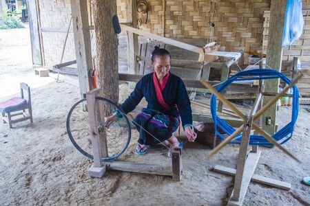 LUANG PRABANG , LAOS - AUG 14 : Laotian weaver in a village near Luang Prabang Laos on August 14 2018. nearly 70 percent of the population in Laos lives in villagesのeditorial素材