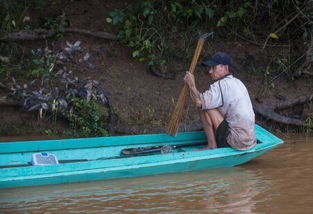 LUANG PRABANG , LAOS - AUG 12 : Laotian fisherman at the Mekong river in Luang Prabang Laos on August 12 2018 , The Mekong is one of the longest rivers of Asiaのeditorial素材