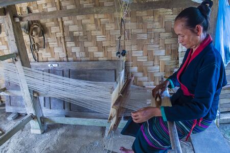 LUANG PRABANG , LAOS - AUG 14 : Laotian weaver in a village near Luang Prabang Laos on August 14 2018. nearly 70 percent of the population in Laos lives in villagesのeditorial素材