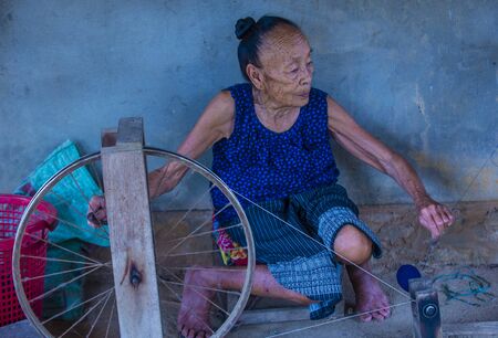 LUANG PRABANG , LAOS - AUG 14 : Laotian weaver in a village near Luang Prabang Laos on August 14 2018. nearly 70 percent of the population in Laos lives in villagesのeditorial素材