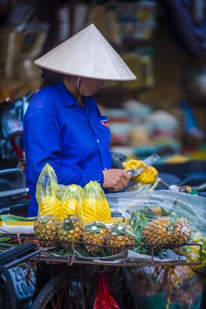 HANOI , VIETNAM - SEP 06 : Vendor in a market in Hanoi Vietnam on September 06 2018. Markets in Hanoi are always bustling with hundreds of stalls selling fresh productsのeditorial素材