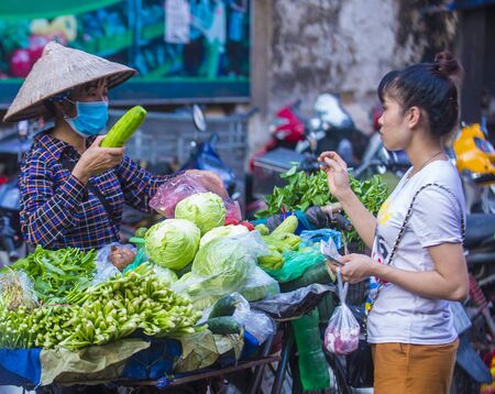 HANOI , VIETNAM - SEP 06 : Vendor in a market in Hanoi Vietnam on September 06 2018. Markets in Hanoi are always bustling with hundreds of stalls selling fresh productsのeditorial素材