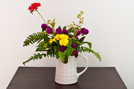 Colorful flowers in white cup, Thailand.の写真素材