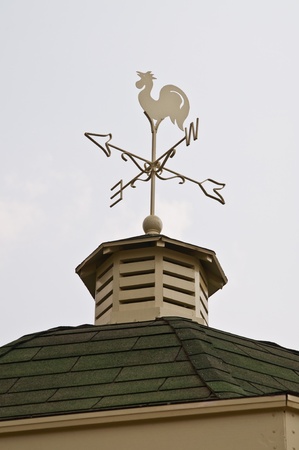 White weather vane on roof, Thailand.の写真素材