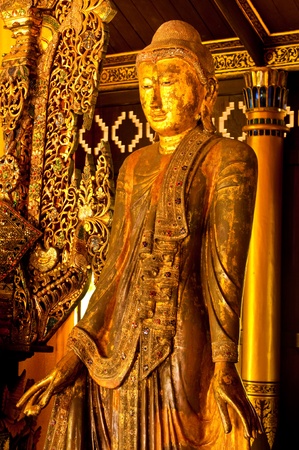 Standing wood buddha at the temple, Thailand.の写真素材