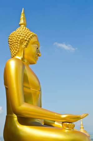 Golden buddha statue with blue sky, Thailand.の写真素材
