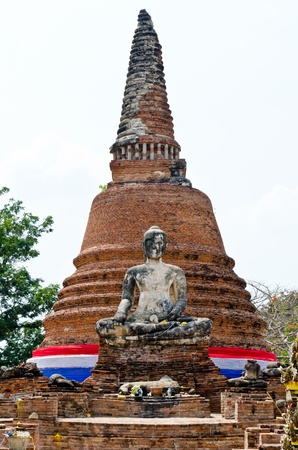 Old buddha statue and pagoda with white sky, Thailand.の写真素材