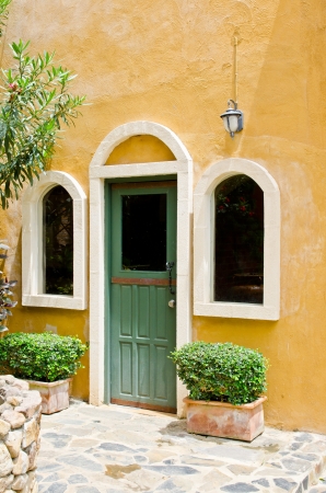 Door and window with yellow wall, Thailand の写真素材