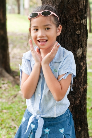Portrait of beautiful little asian girl in the park, Thailand.の写真素材
