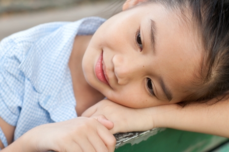 Head shot portrait of beautiful little asian girl in the park, Thailand.の写真素材