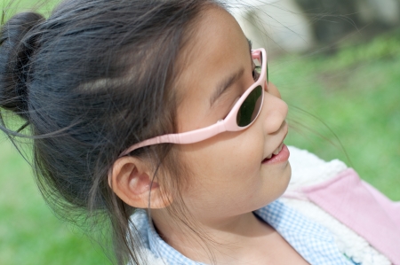 Head shot portrait of lovely asian girl in pink sweater, Thailand.の写真素材