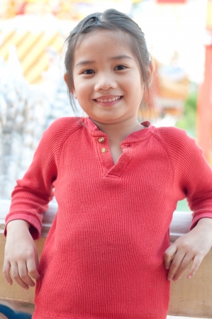 Beautiful asian girl in red suit at Chinese temple, Thailand.の写真素材