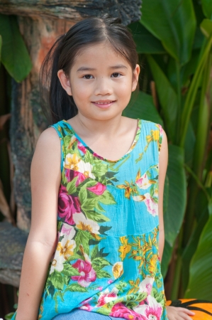 Porttrait of beautiful Thai girl in blue dress at the zoo, Thailand.の写真素材
