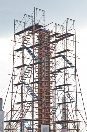 Column with scaffolding in construction site, Thailand.の写真素材