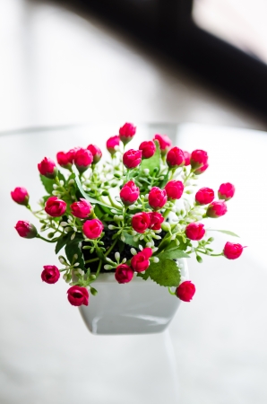 Plastic flower on white table, Thailandの写真素材