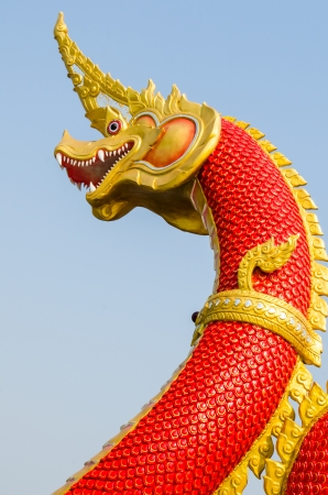 Red Naga statue on blue sky, Thailandの写真素材