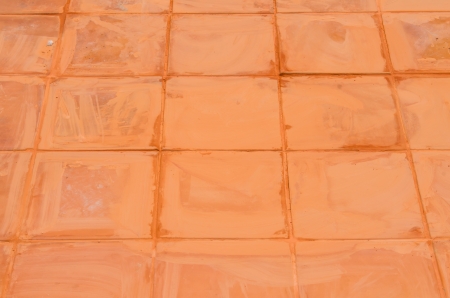 Orange ceramic tile under installation, Thailandの写真素材