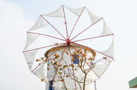 Wildmill with white building, Thailandの写真素材