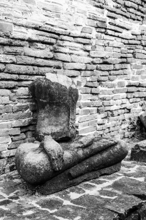 Old buddha statue and old wall at Mahathat temple, Thailandの写真素材