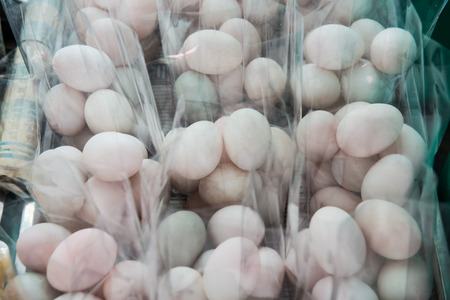 Duck eggs in plastic bag on sale stand, Thailand.の写真素材