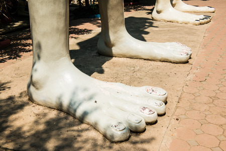 Foot of Hungry Ghost Statue at Thai Temple, Thailand.の写真素材