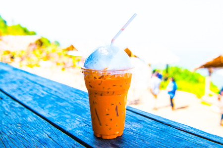 Iced Milk Tea on Wooden Table, Thailand.